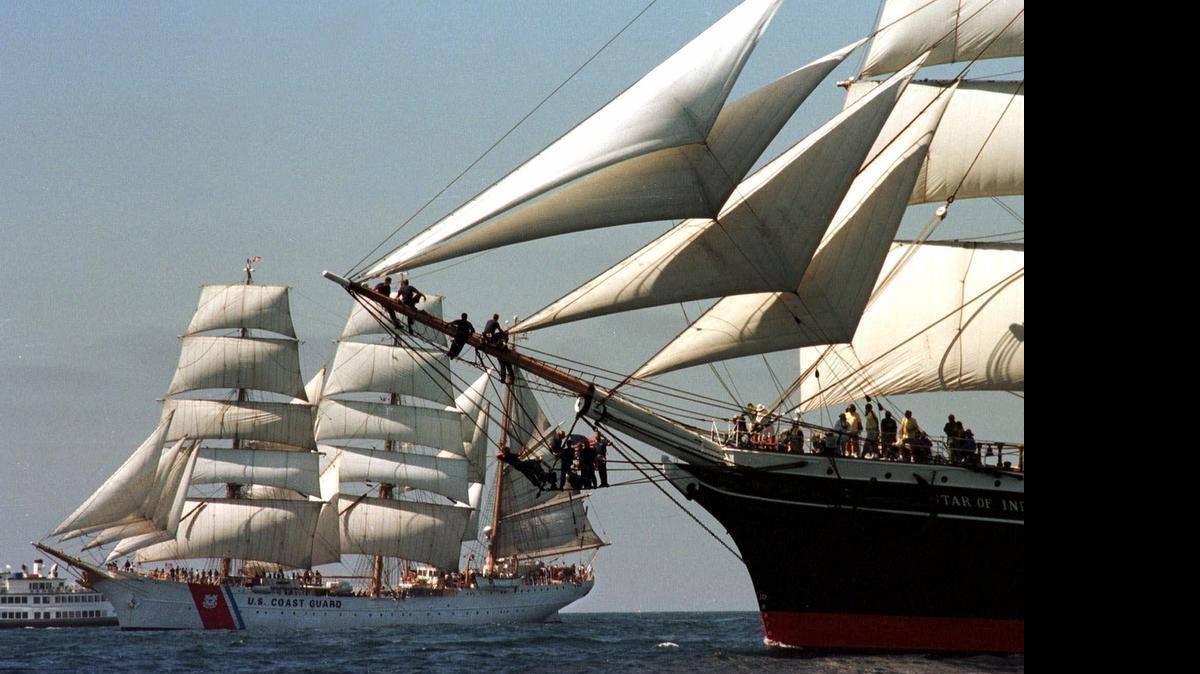 
Crew members of the San Diego Maritime Museum's "Star of India," right, line up on the bow sprit to catch a good view of the U.S. Coast Guard's sailing ship, "Eagle.” Nine lawmakers reported $800,000 in behested payments apiece to the museum during the first half of 2015, according to state filings.
