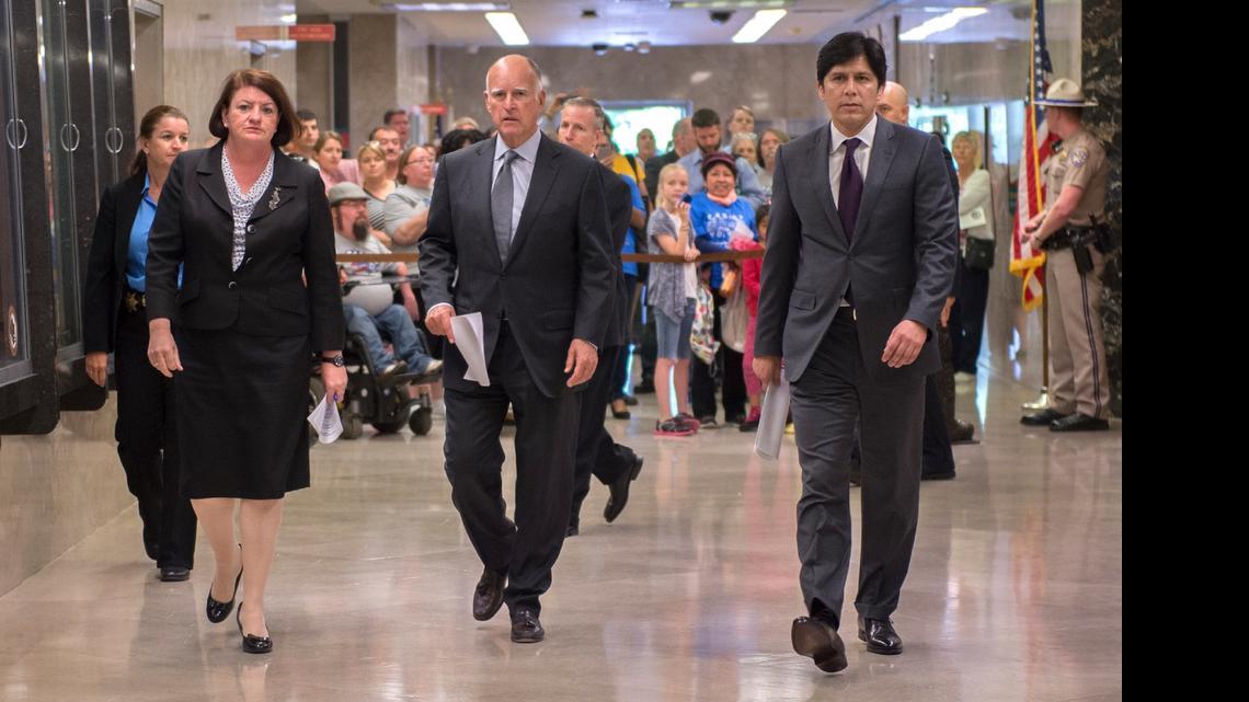 
California Gov. Jerry Brown, center, flanked by Assembly Speaker Toni Atkins, D-San Diego, left, and Senate President Pro Tem Kevin de León, D-Los Angeles, right, walk to a news conference to announce a budget agreement Tuesday.
