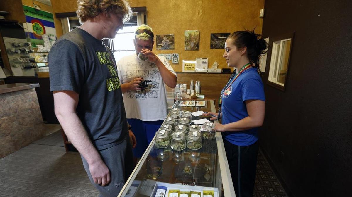 
Customers shop for retail marijuana at 3D Cannabis Center, in Denver, Thursday, May 8, 2014. 

