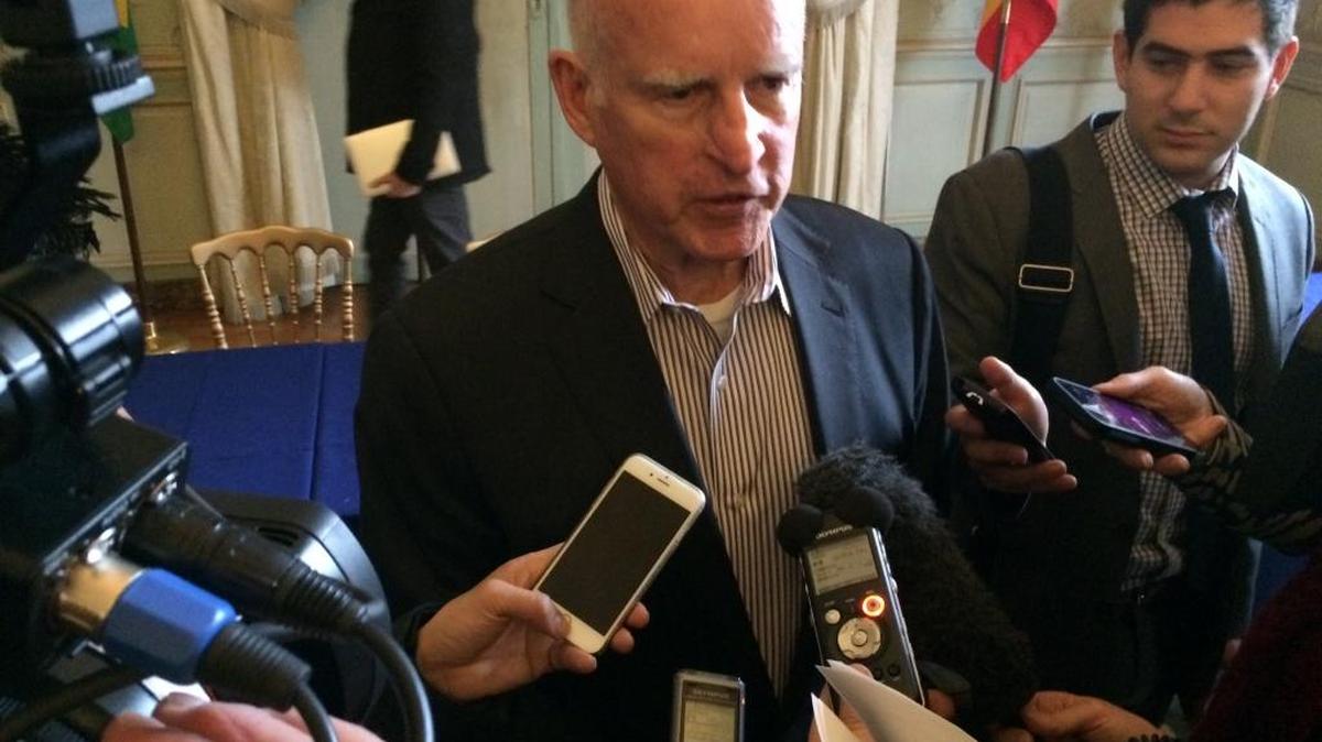 Gov. Jerry Brown speaks with reporters in Paris on Dec. 6, 2015.