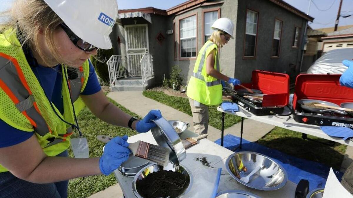 Sara Redding, left, a field sampling team leader for the Los Angeles County Health Department, and Jaime Jarrett, an environmental health specialist, prepare soil samples to be tested for possible lead contamination from the shuttered Exide battery recycling plant on Feb. 29, 2016.