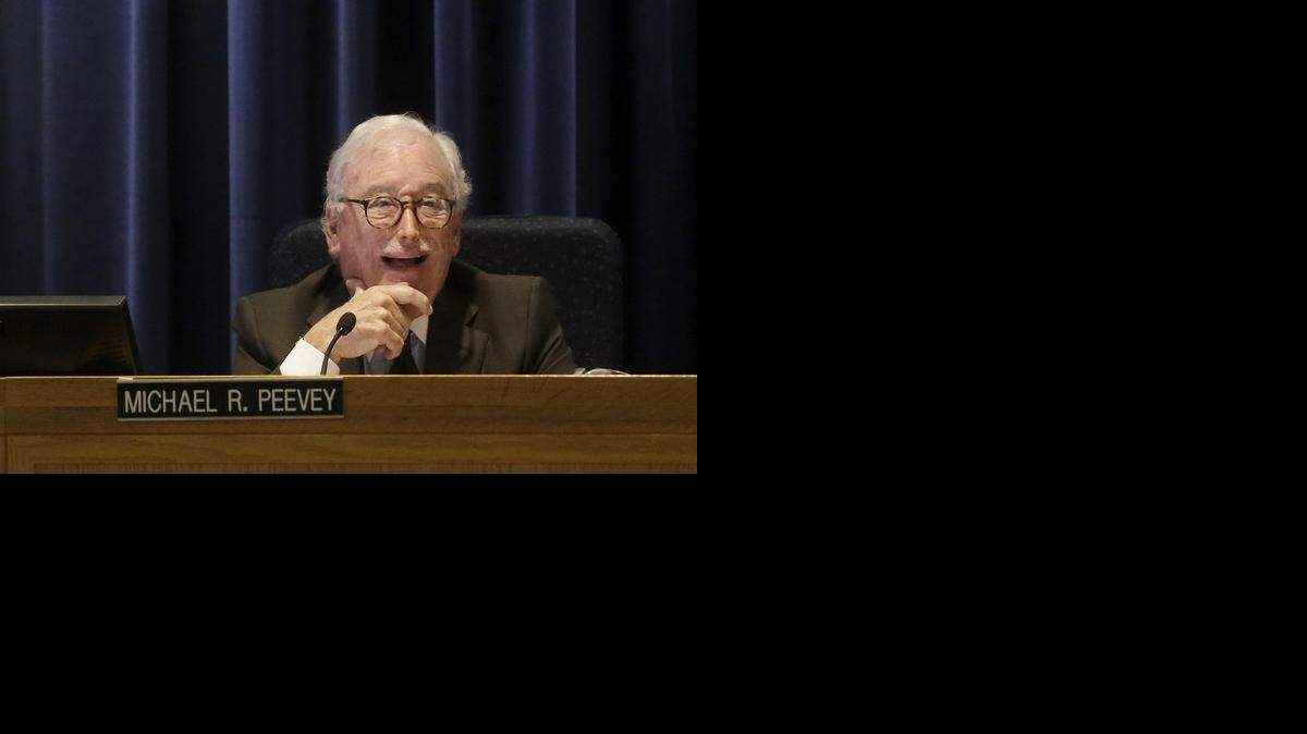 
California Public Utilities Commission President Michael Peevey laughs during his final meeting in San Francisco on Dec. 18, 2014.
