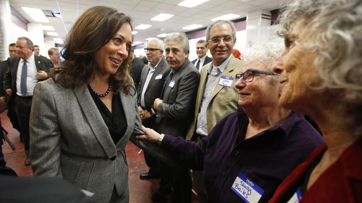 Attorney General Kamala Harris, left, a candidate for the U.S. Senate, talks with supporters Shelly Bailes, second from right, and Ellen Pontac, right, at a campaign gathering Thursday, Jan. 21, 2016, in Sacramento, Calif.