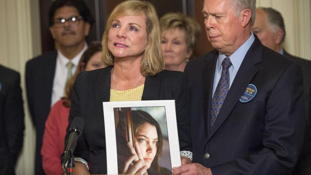 Deborah Ziegler holds a photo of her daughter, Brittany Maynard, with her husband Gary Holmes, after the California Senate passed SB 128, a bill that would allow physicians to assist in the death of terminally ill patients, on May 4, 2015.