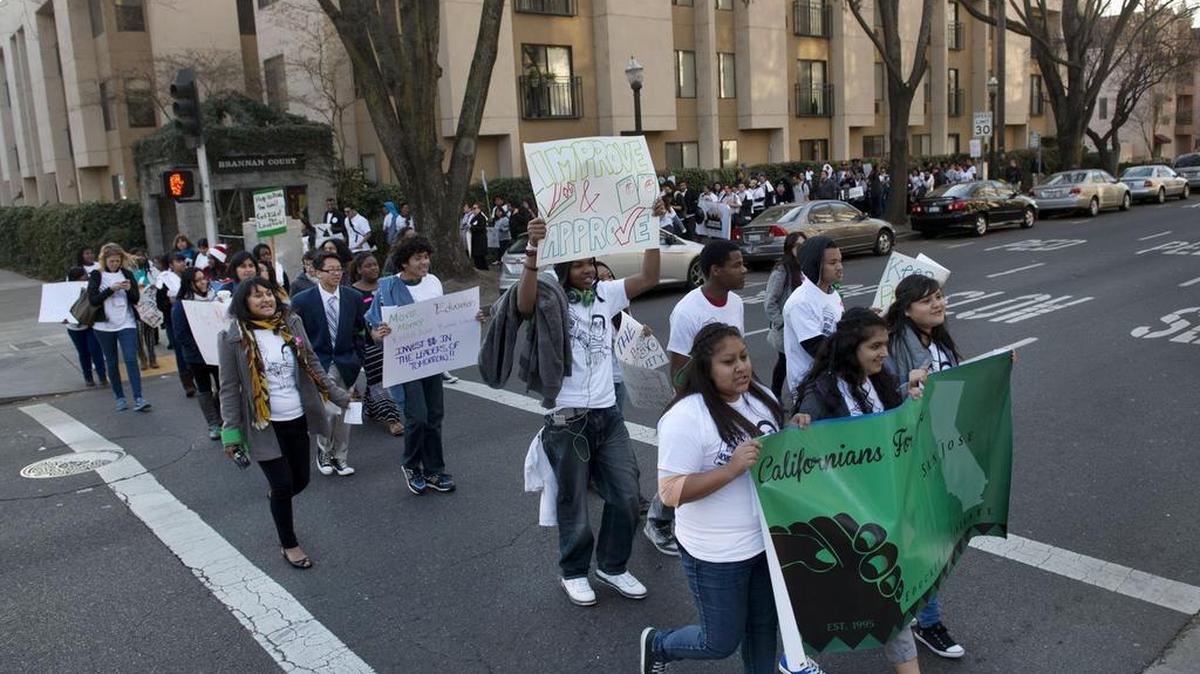 
Students, parents and advocates from across the state cross 15th Street during their march around the California Department of Education building at 15th and N streets in Sacramento in 2014.
