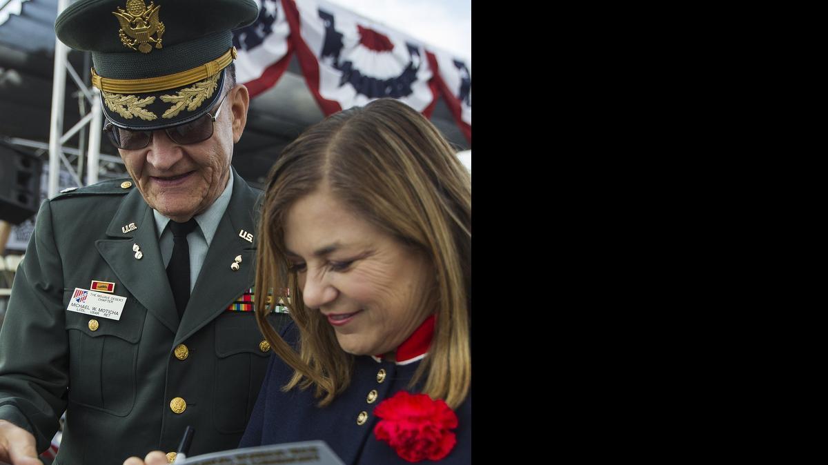 
U.S. Rep. Loretta Sanchez signs a program for Michael Moticha, Ltc. USAR Retired, during the 2014 Orange County Veterans Day Community Celebration at the OC Fairgrounds.
