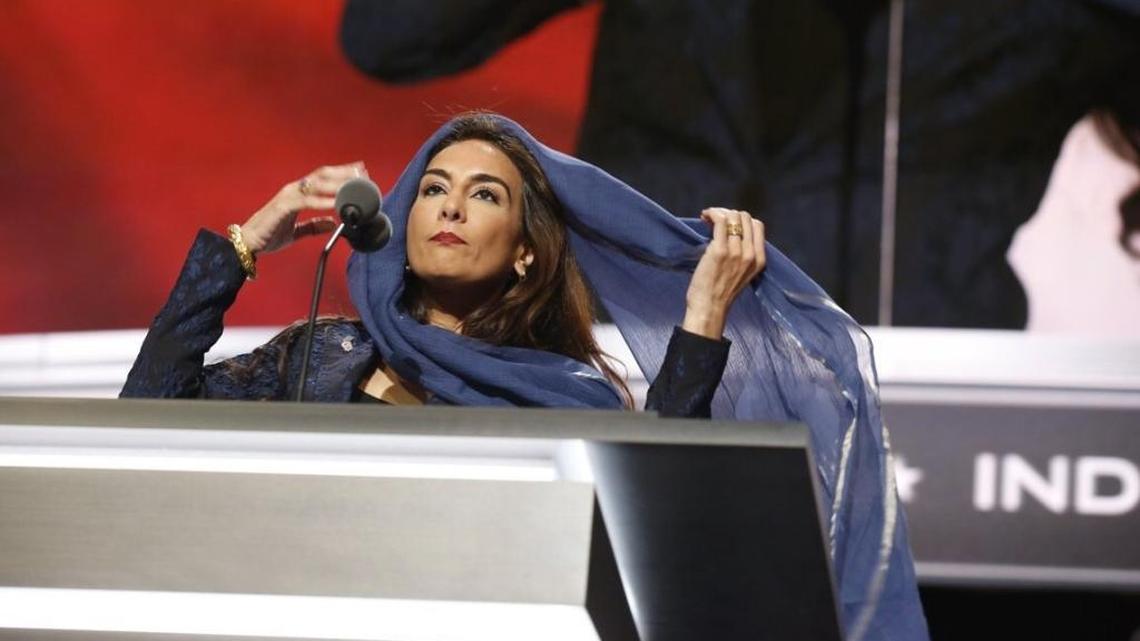 Harmeet Dhillon covers her hair as she conducts the invocation during the second day of the Republican National Convention in Cleveland on July 19, 2016.