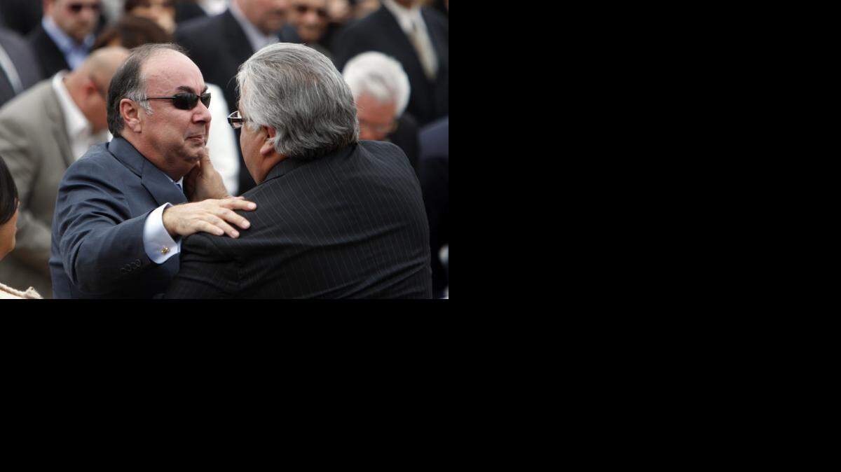 
Ron Calderon, right, comforts his brother Tom Calderon during a memorial service for Tom’s wife Marcella Calderon in January 2012.
