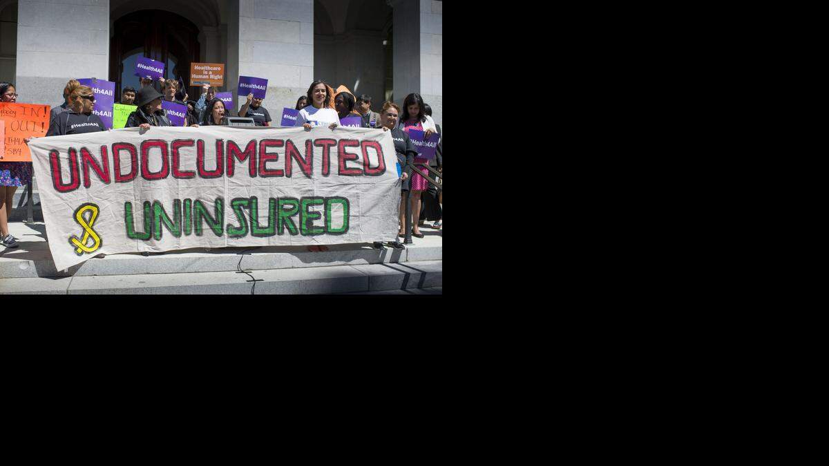 
Akiko Aspillaga of San Francisco reads a poem at a rally for SB 4, a bill to provide health care to undocumented immigrants, Wednesday at the Capitol.
