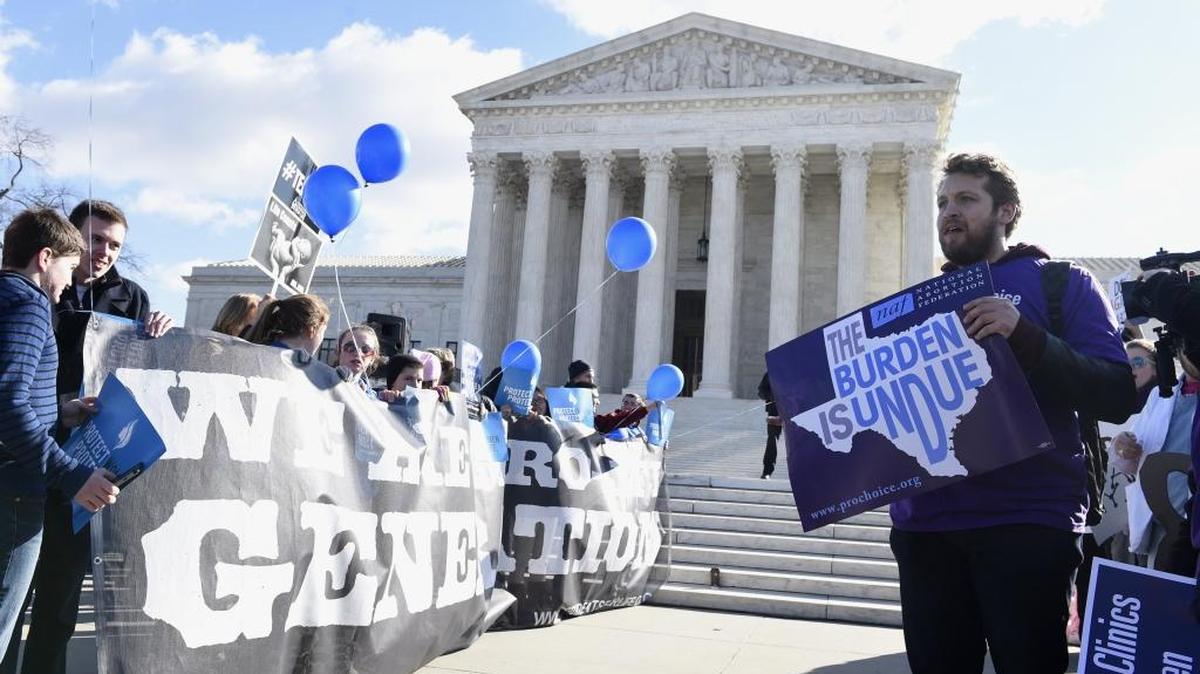 Pro-abortion rights protester Sarp Aksel of New York City, right, and anti-abortion protesters, left, rally outside the Supreme Court in Washington, Wednesday, March 2, 2016. A proposed California constitutional amendment to require parental notification for abortions failed this week.