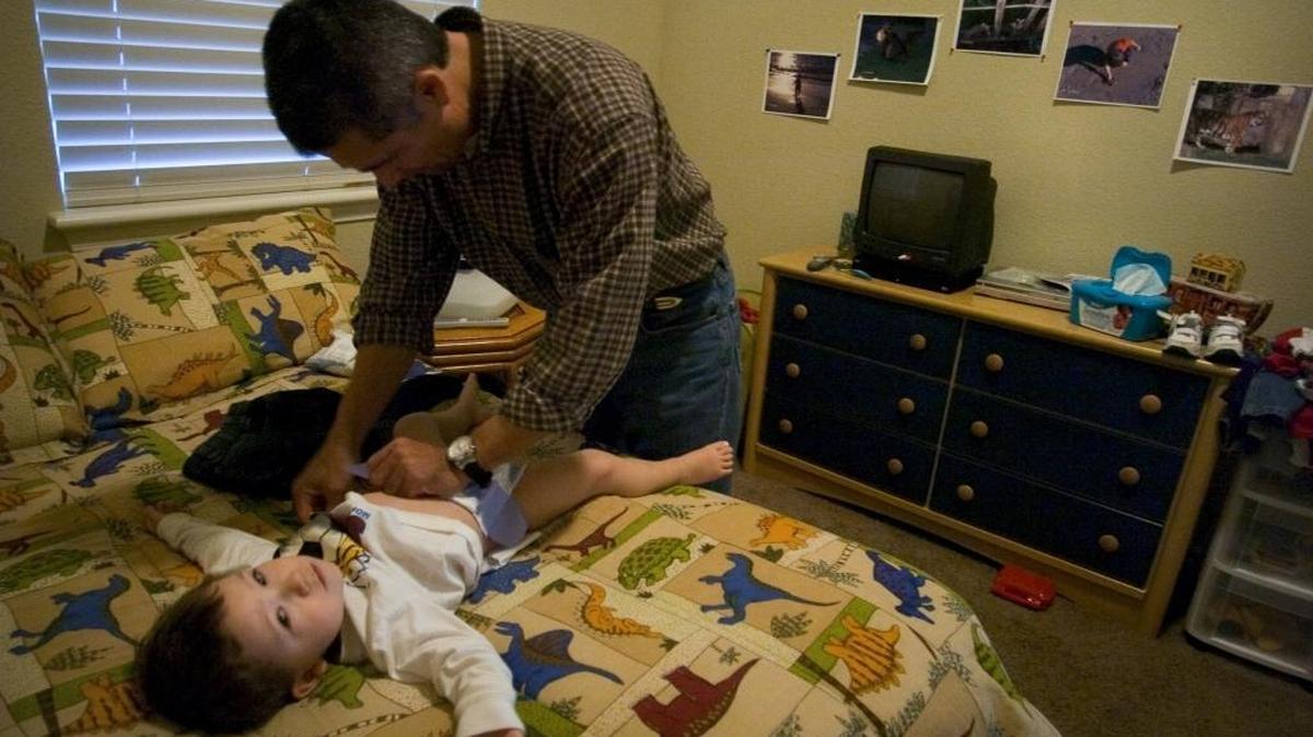 Peter Kosinski changes the diaper of his 2-year-old son, Aiden, after coming home from work in 2006. Assembly Bill 1127 by Assemblyman Ian Calderon, D-Whittier, would require public buildings and venues to include at least one baby diaper-changing station accessible to both women and men. A previous version of the measure was vetoed in 2014 by Gov. Jerry Brown.