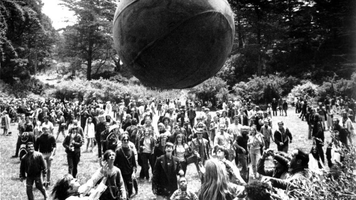 People keep a large ball, painted to represent a world globe, in the air during a gathering at Golden Gate Park in San Francisco to celebrate the summer solstice June 21, 1967, the first day of the Summer of Love.