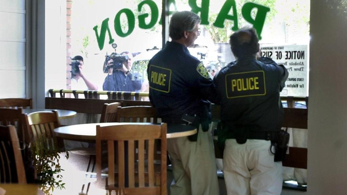 Investigators from the California Department of Alcoholic Beverage Control post “notice of suspension” signs on the windows of Paragon Bar in Davis in 2001. There were almost 90,000 alcohol licensees statewide as of mid-2015.