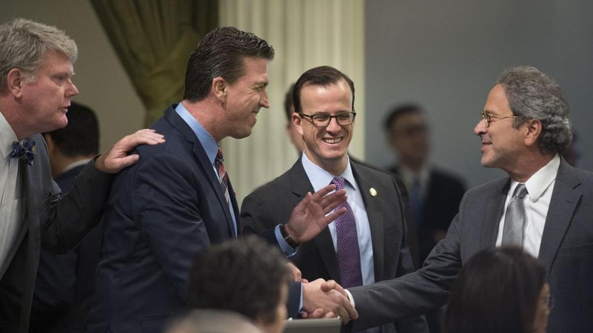 Kevin Mullin, D-San Mateo, second from left, is congratulated by fellow Democrats Mark Stone, left, Richard Bloom, right, and Marc Berman after Mullin’s bill, AB 249 passed on the Assembly floor Sept. 15.