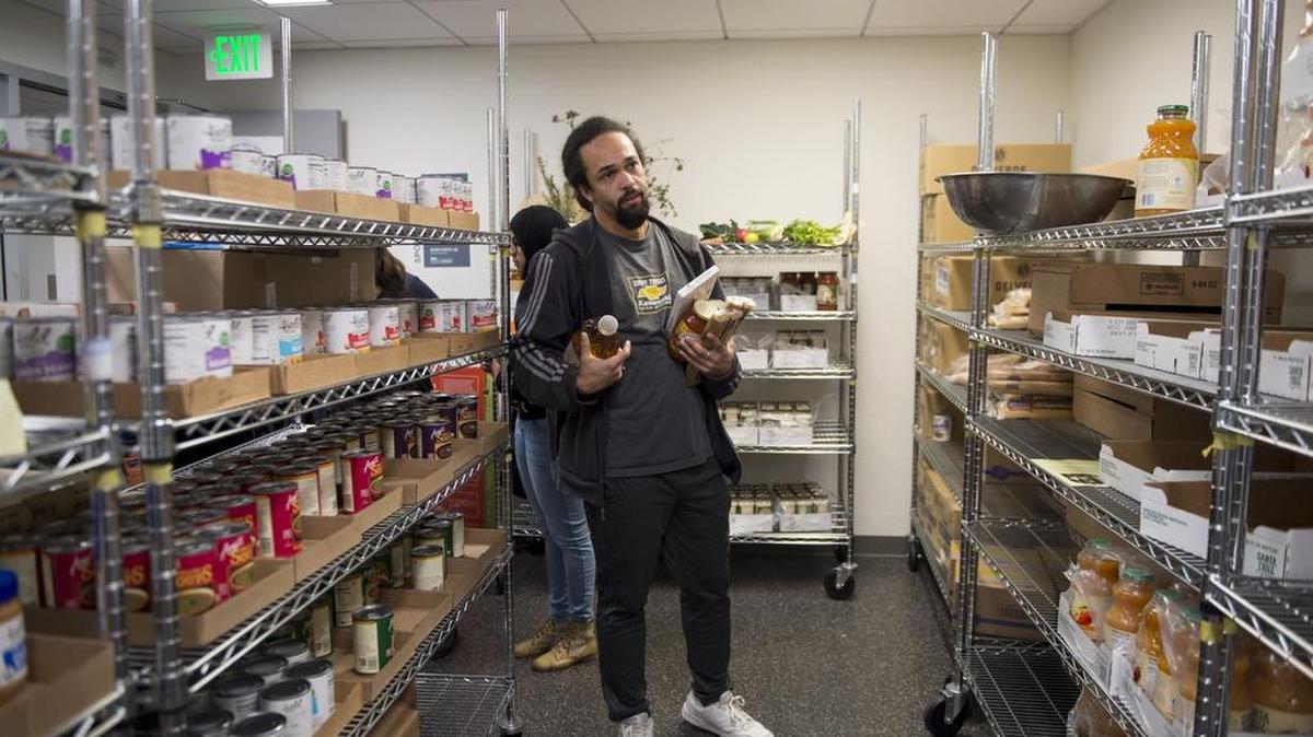 Justin Mandich, a junior environmental science student, shops for pasta sauce, noodles and breakfast food earlier this month at the Food Pantry at UC Berkeley’s MLK Student Union. Mandich says he usually visits the student-run pantry twice a month. “It helps a lot. I’m on food stamps too, and I usually run out in the third week,” he says.