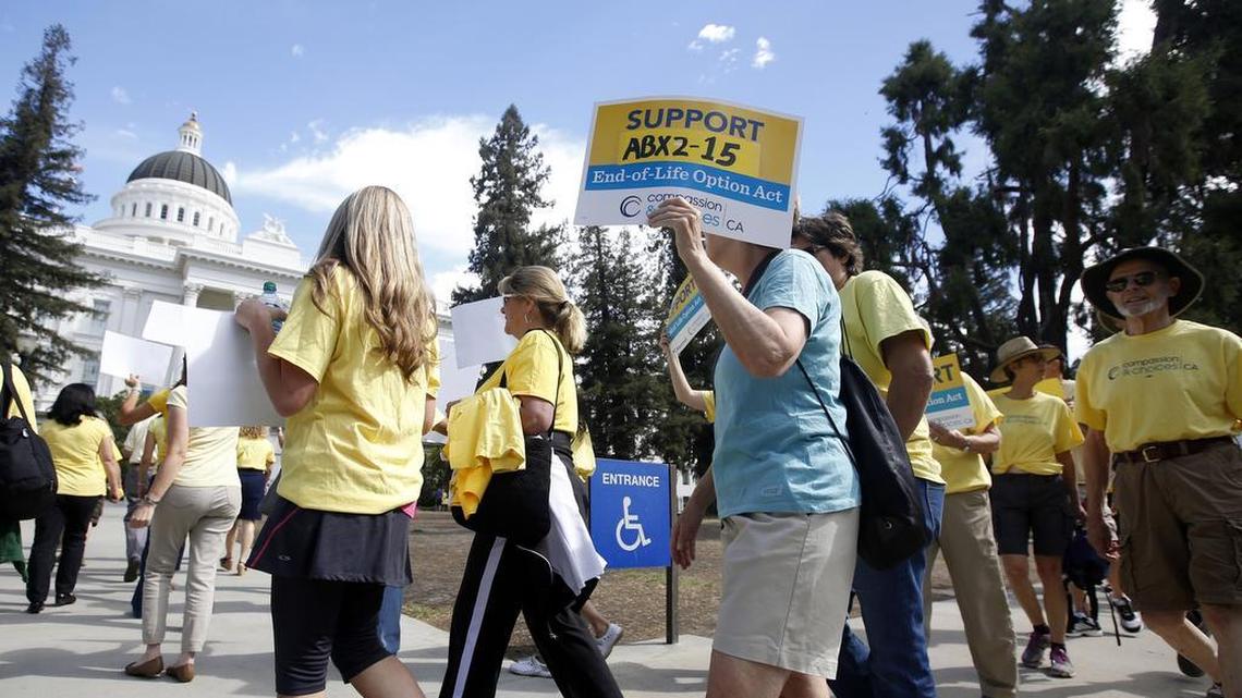 Supporters of a measure to allow the terminally ill to end their own life march at the Capitol while calling on California Gov. Jerry Brown to sign the bill Thursday, Sept. 24, 2015. Opponents have gone to court to block the law.