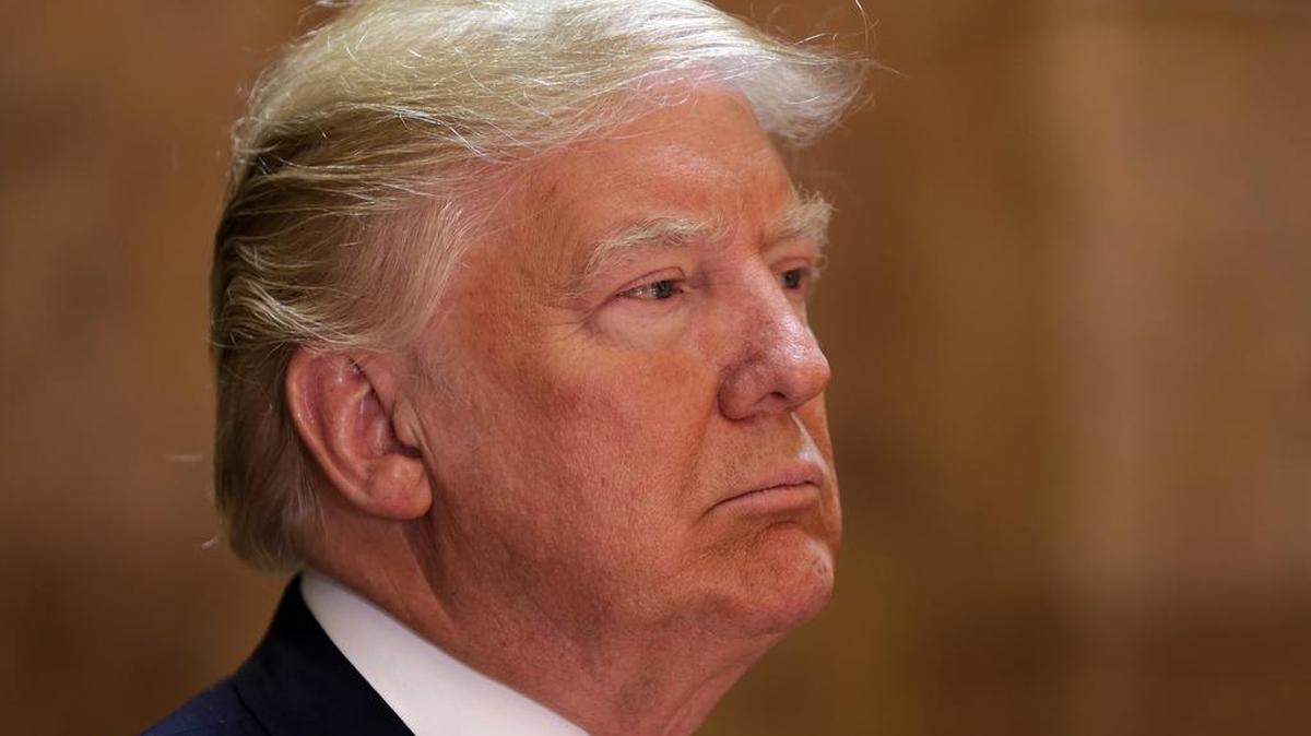 Donald Trump listens to introductory remarks before speaking at the Trump Tower.