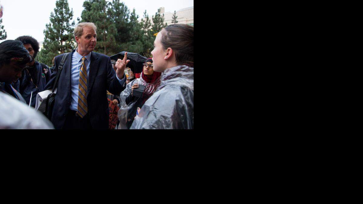 
UC Executive Vice President and Chief Financial Officer Nathan Bostrom speaks to protesters outside the UC Regents meeting, Nov. 19, 2014 in San Francisco. Student protesters blocked off the entrances, forcing regents and UC staff to force their way in.
