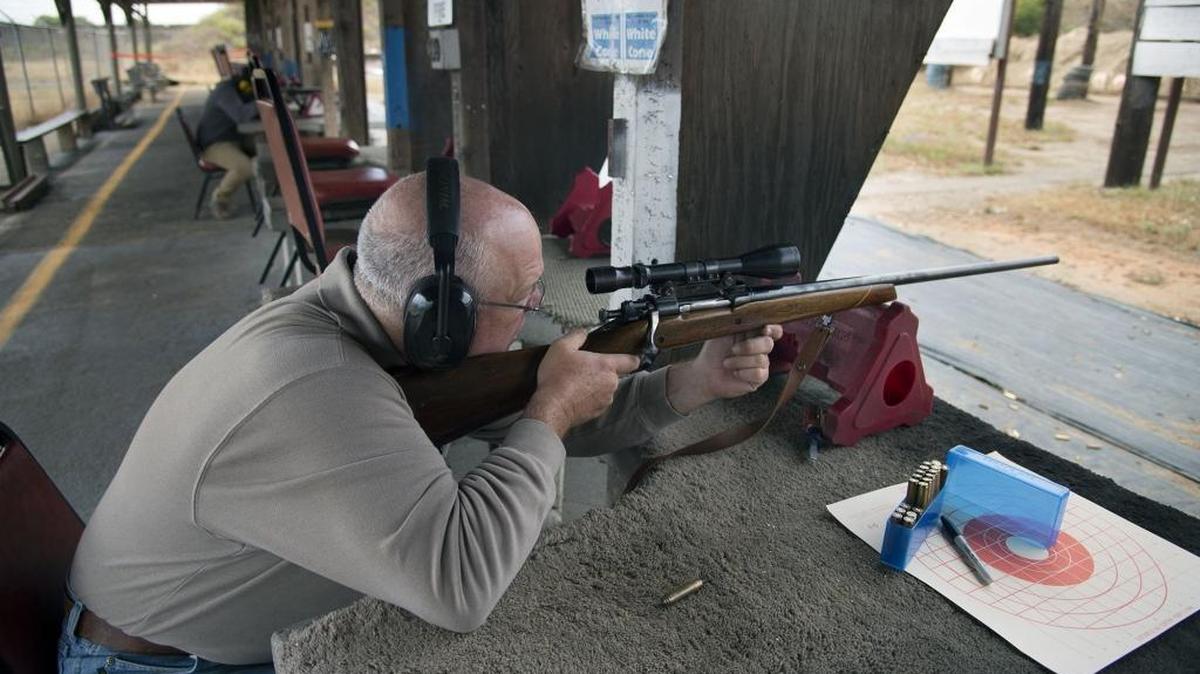 Gary Crain of Folsom fires a rifle at the Cordova Shooting Center in June in Rancho Cordova. A bill on Gov. Jerry Brown’s desk would prohibit openly carrying long guns such as rifles in unincorporated areas where county supervisors already have banned shooting. Gun ranges would be exempt.