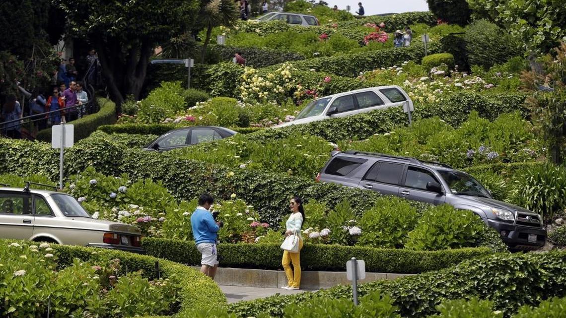 Motorists make their way down Lombard Street on Tuesday, May 20, 2014, in San Francisco. San Francisco’s crooked street could soon be closed to tourists in the summertime. A transportation commission is scheduled to consider an experimental shutdown of the famously curvaceous block of Lombard Street plus an adjoining block where cars line up and wait.