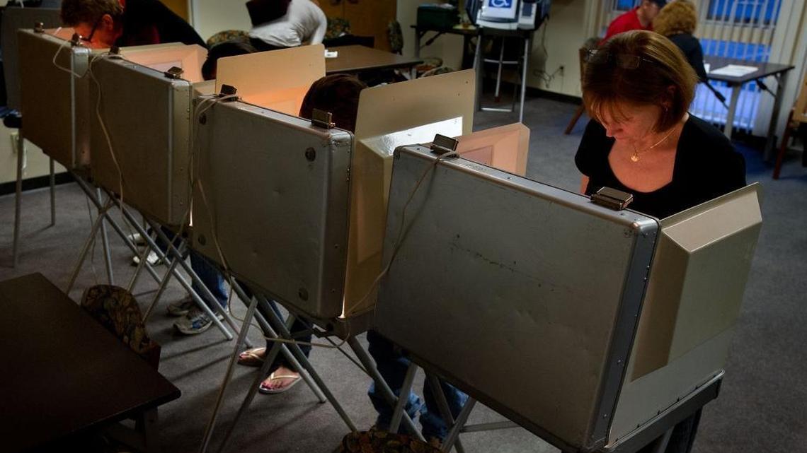 Voters including Debora Smith, right, cast their ballots at the polling place at El Dorado County Senior Center in El Dorado Hills on Nov. 6, 2012.