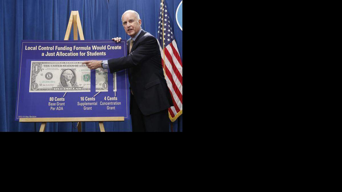 
Gov. Jerry Brown gestures to a chart showing his plan to give more local control over education funding as he discussed his revised 2013-14 state budget plan at the Capitol in Sacramento, Calif., Monday, May 13, 2013.

