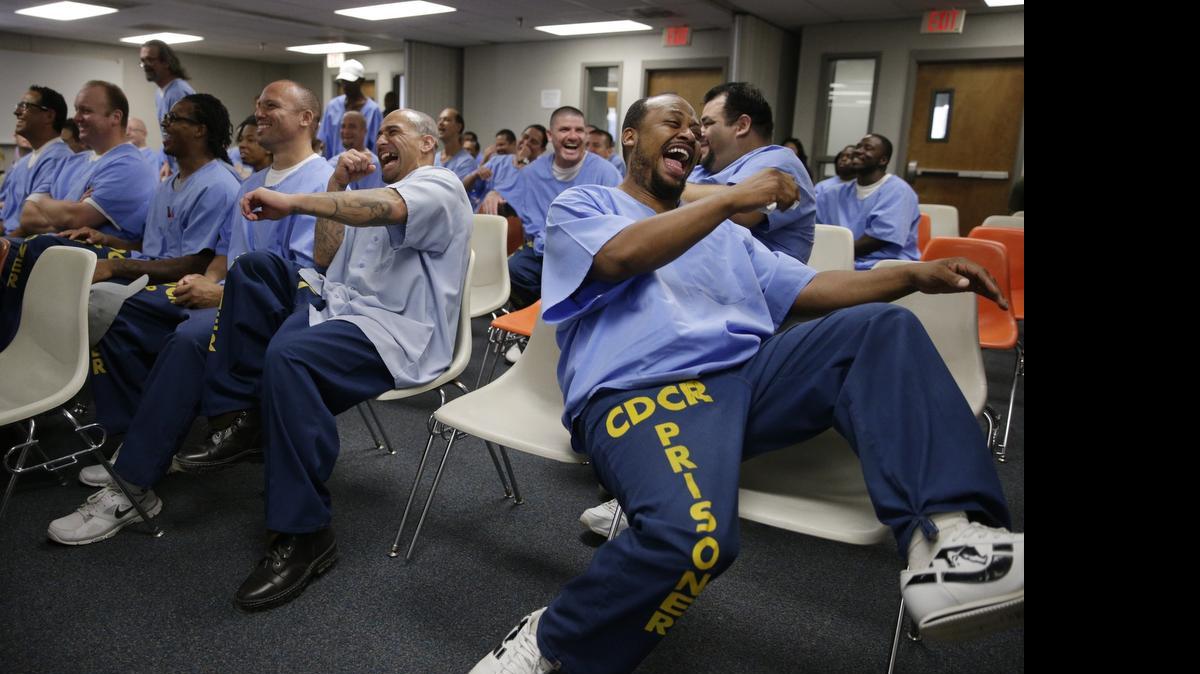 
In this Sept. 30, 2014, photo, inmates laugh while watching inmate actors perform during an Actors' Gang Prison Project workshop, an outreach program led by actor Tim Robbins, at the California Rehabilitation Center in Norco, Calif. The nonprofit acting program is expanding thanks to its slice of a $2.5 million arts pilot project from the California Department of Corrections and Rehabilitation.
