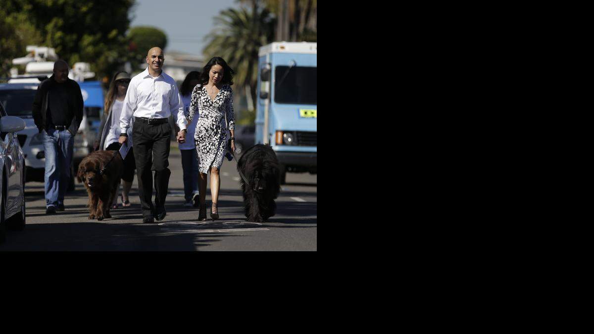 
Republican Neel Kashkari walks to his polling place with girlfriend Christine Ong and his two dogs on Tuesday, Nov. 4, 2014 in Laguna Beach, Calif.
