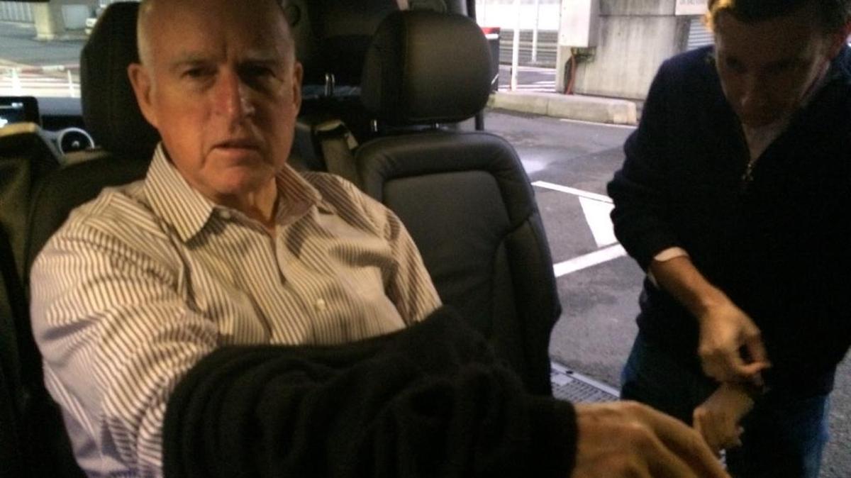 Gov. Jerry Brown arrives at Charles de Gaulle Airport, outside of Paris, on Dec. 10, 2015.
