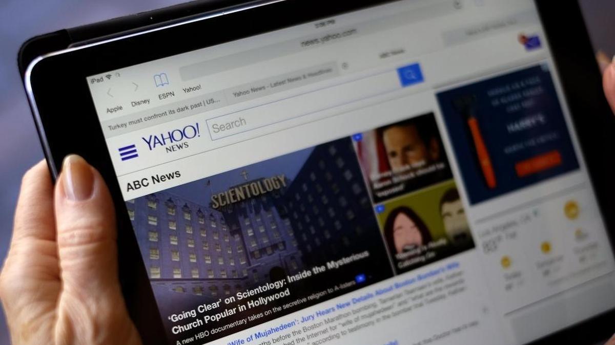 An unidentified person uses an iPad to read Yahoo/ABC News on the internet in Los Angeles on Tuesday, April 28, 2015.