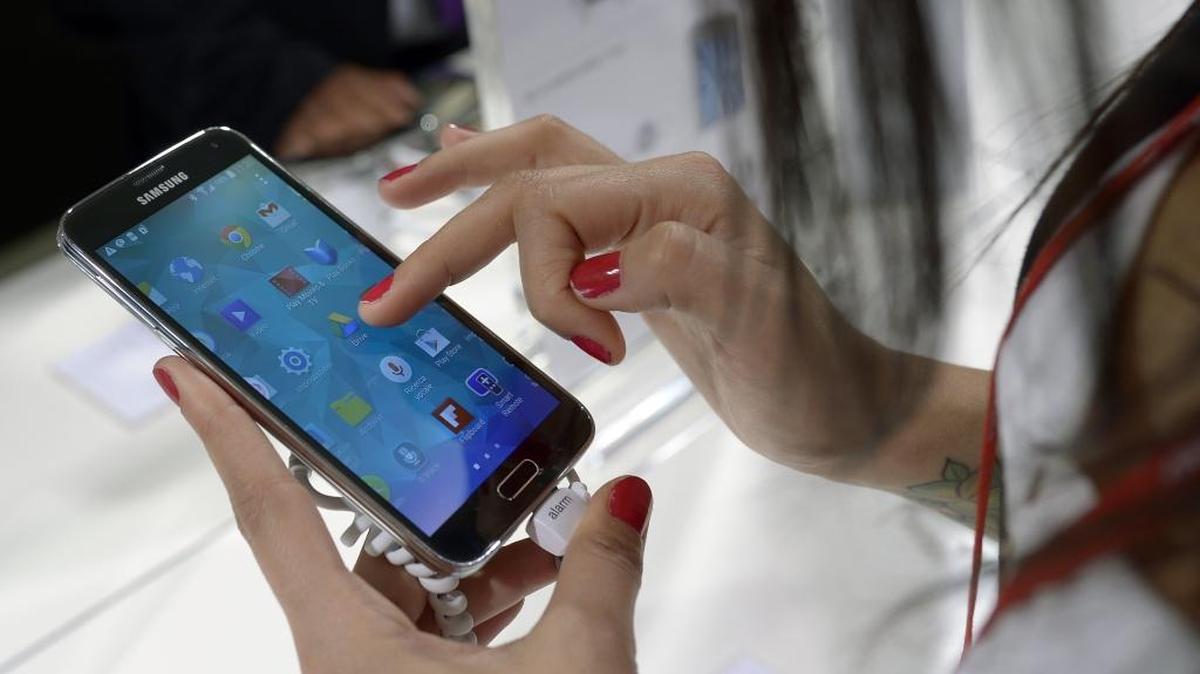 In this Feb. 25, 2014, file photo, a Samsung Galaxy S5 is demonstrated at the Mobile World Congress, the world's largest mobile phone trade show in Barcelona, Spain.