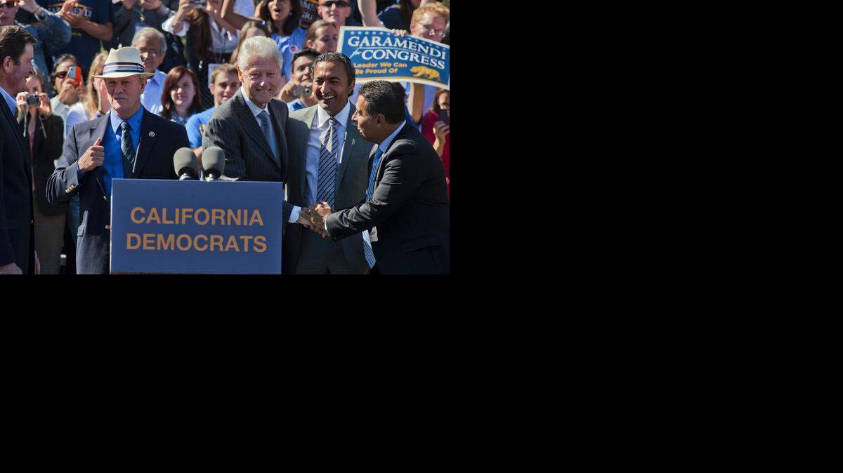 
Former President Bill Clinton, center, is greeted by candidates for Congress Ami Bera and Jose Hernandez, at right, as he stumped for them and Rep. John Garamendi and Jerry McNerney, at left, in 2012 in Davis. Clinton will be there again Wednesday for Bera and Garamendi.

