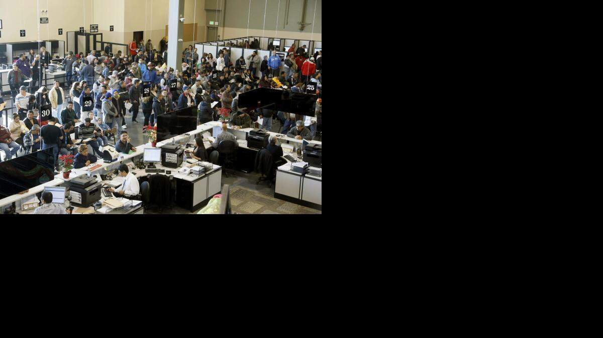 
Immigrants line up at a California Department of Motor Vehicles office to register for drivers licenses in Stanton, Calif., Friday, Jan. 2, 2015.
