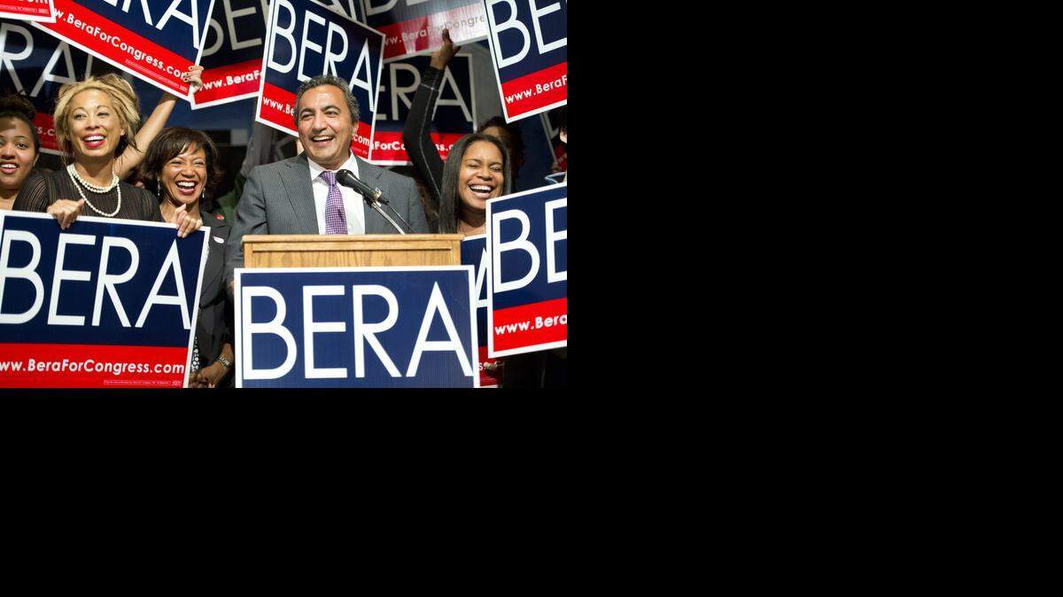 
Rep. Ami Bera, D-Elk Grove, flanked by his wife Janine Bera, left, and daughter Sydra Bera, right,  receives applause on election night at the Elks Lodge in Carmichael. The ballot count showed Wednesday that Bera had successfully defended his congressional seat against former GOP Rep. Doug Ose.
