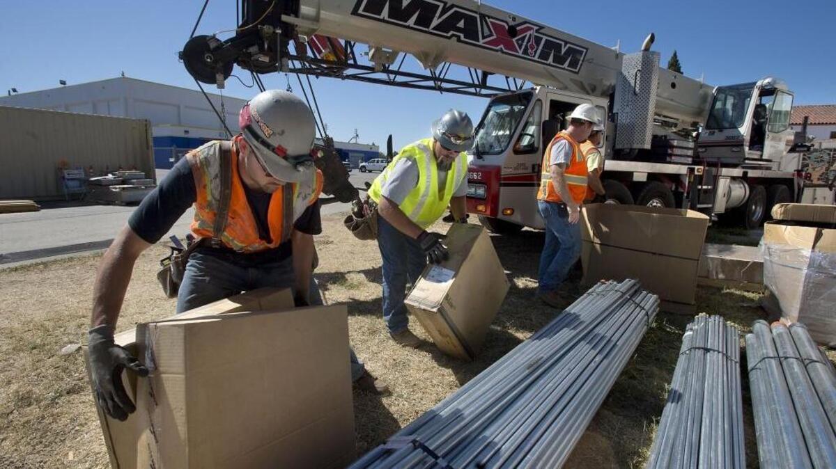 Construction crews prepare to use a large crane to remove HVAC units form the roof of Grant High School in Sacramento on June 19, 2014. This week, voters approved the vast majority of local school district bond issues on their ballots.