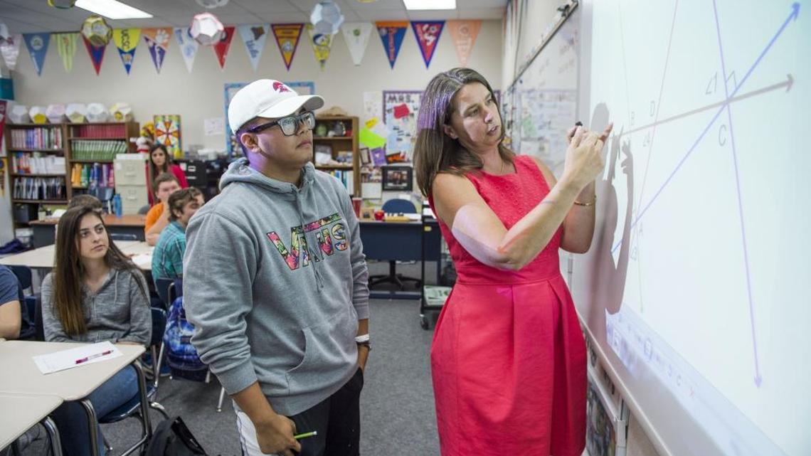 Christian Mattes, 15, center, explains to his teacher Leslie Peoples how he came up with an answer to a geometry problem at Mesa Verde High School on May 23, 2016.