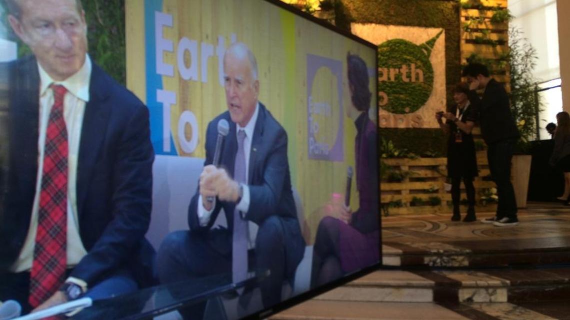 Billionaire Tom Steyer, left and Gov. Jerry Brown speak at an event in Paris on Dec. 7, 2015.