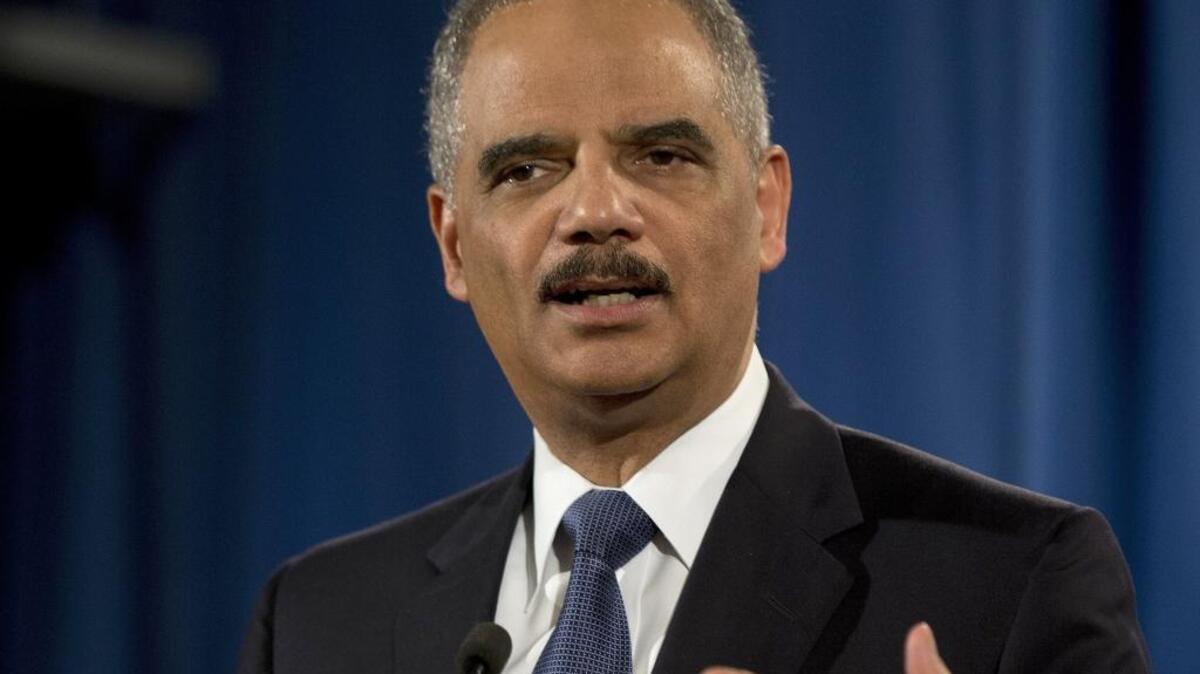 In this March 2015 photo, then-Attorney General Eric Holder speaks at the Justice Department in Washington.