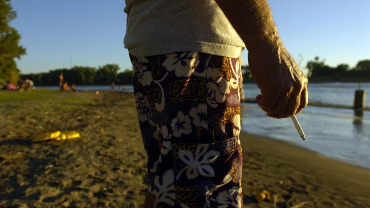 A visitor smokes a cigarette in Discovery Park on July 26, 2006.