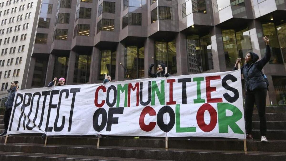 Protesters rally at 555 California St., the only partially Trump-owned building in San Francisco, on Friday, Jan. 20, 2017. Protests against the new administration also occurred in Los Angeles, Oakland and Sacramento.