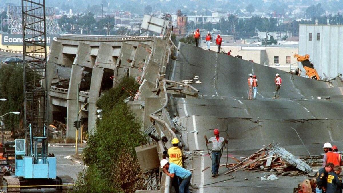 In this Oct. 19, 1989 file photo, workers check the damage to Interstate 880 in Oakland, Calif., after it collapsed during the Loma Prieta earthquake.
