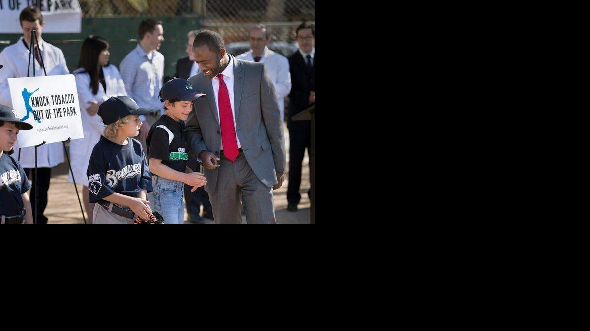 
Jonah Broscow, 10, second from left, talks to Assemblyman Tony Thurmond, D-Richmond, in Sacramento’s Roosevelt Park on Tuesday after speaking about the impact of tobacco use on athletes. Already banned in minor-league parks, tobacco use would be prohibited at every baseball venue in California under legislation Thurmond has proposed.
