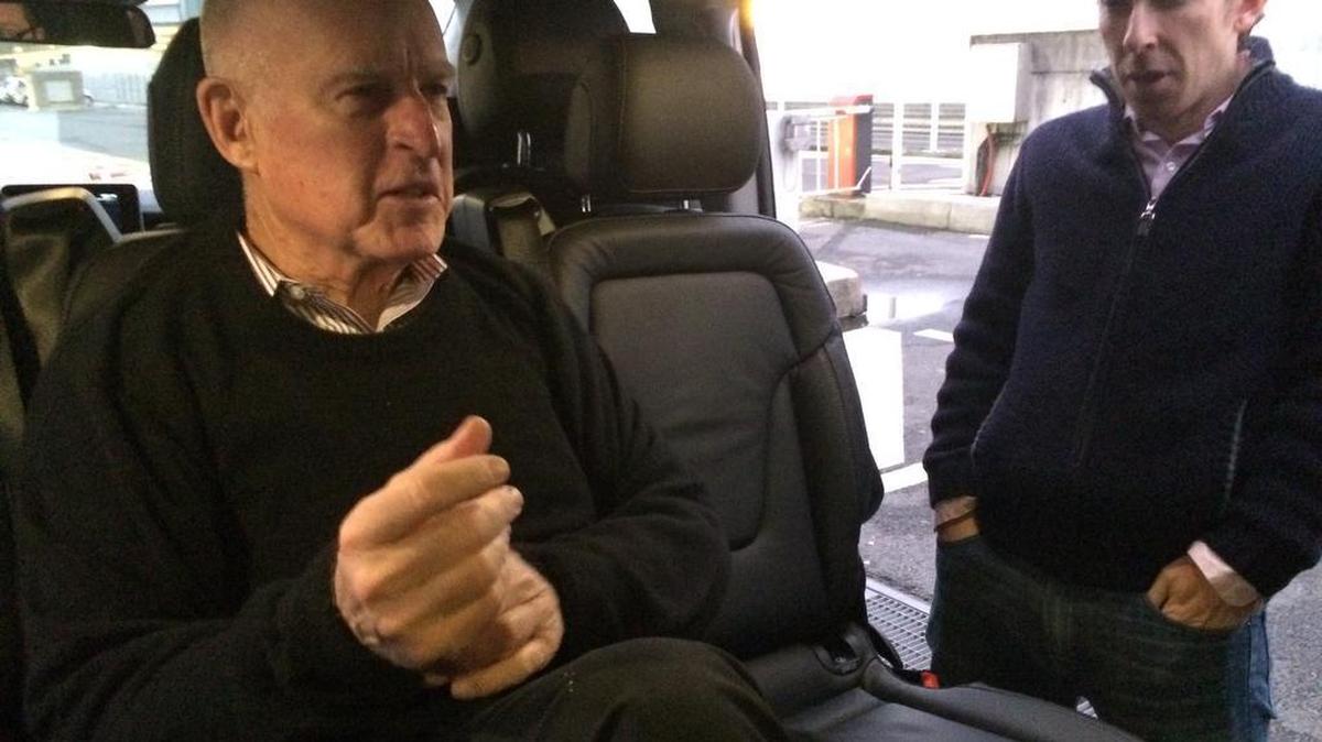 Gov. Jerry Brown, left, and his press secretary, Evan Westrup, arrive at Charles de Gaulle Airport, outside of Paris, on Dec. 10, 2015.