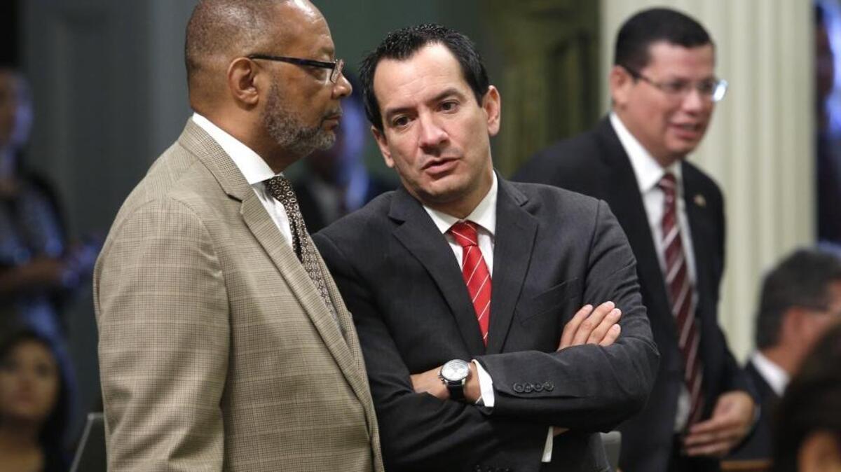 In this photo taken Sept. 2, 2015, Assemblyman Reginald Jones-Sawyer, D-Los Angeles, left, talks with Assembly Anthony Rendon, D-Lakewood, at the Capitol.