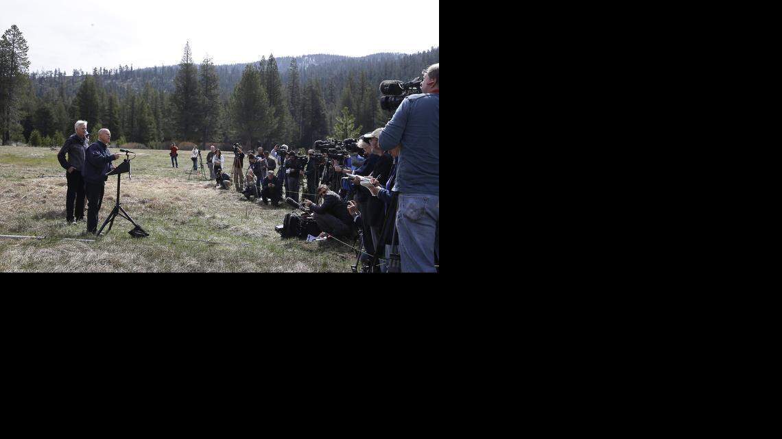 
Gov. Jerry Brown, second from left, talks to reporters about the executive order he signed requiring the state water board to implement measures in cities and towns to cut water usage by 25 percent compared with 2013 levels, near Echo Summit, Calif., Wednesday, April 1, 2015.
