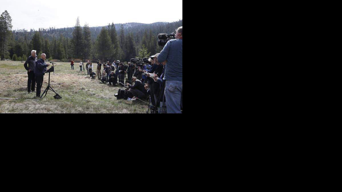 
Gov. Jerry Brown, second from left, talks to reporters about the executive order he signed requiring the state water board to implement measures in cities and towns to cut water usage by 25 percent compared with 2013 levels, near Echo Summit, Calif., Wednesday, April 1, 2015.
