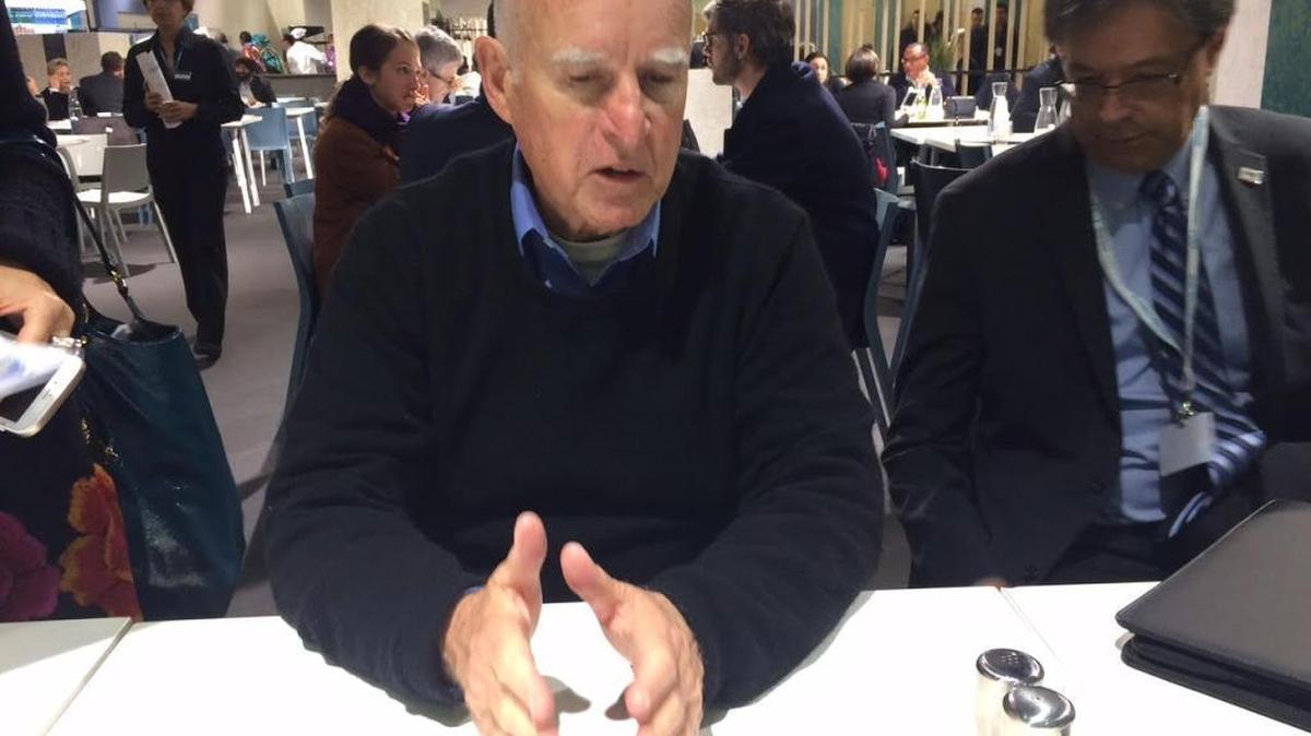 Gov. Jerry Brown speaks with reporters Saturday in Le Bourget, France.