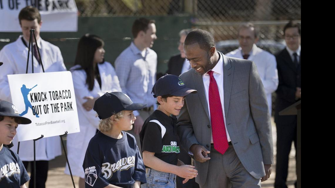 
After giving a short presentation on the impact of tobacco on athletes, Jonah Broscow, 10, of Oakland talks to Assemblyman Tony Thurmond, D-Richmond, following a news conference at Roosevelt Park in February. Already banned in minor-league parks, tobacco use would be prohibited at majorleague baseball venues in California under legislation passed Thursday by the Assembly.
