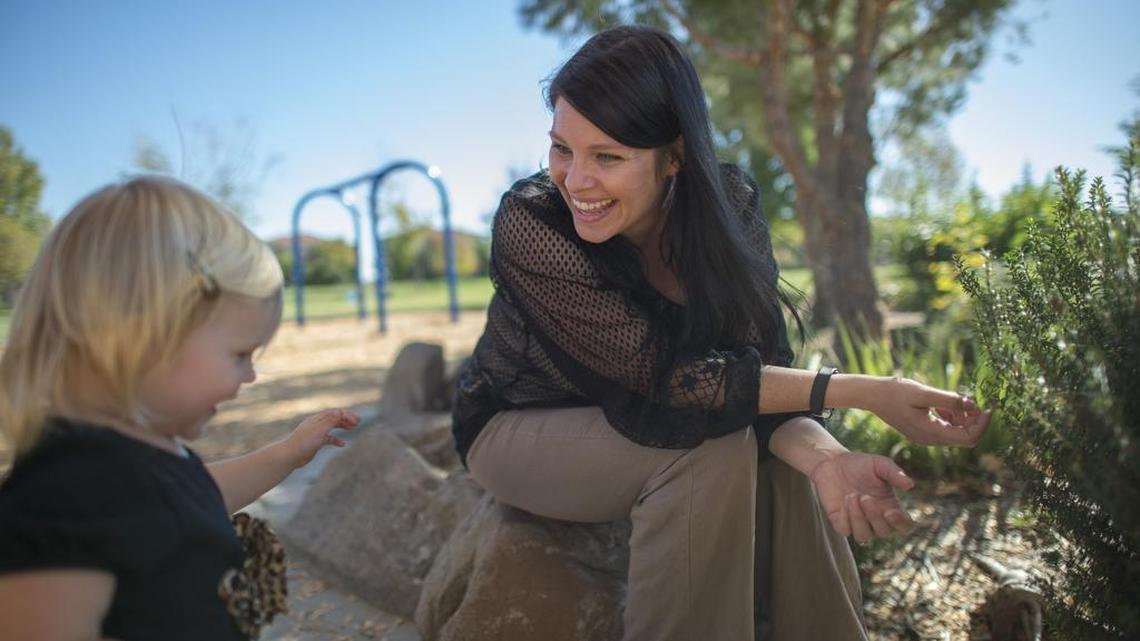Lisa Kaplan, center, says she spends time with her youngest daughter Asha Kaplan-Heiland, 22 months old, two mornings a week at Westlake Community Park in Sacramento, Calif., on Tuesday. "I'm raising my girls to be tough so they can handle themselves. I want them to be able to stand on their own two feet and do whats right," said Kaplan.