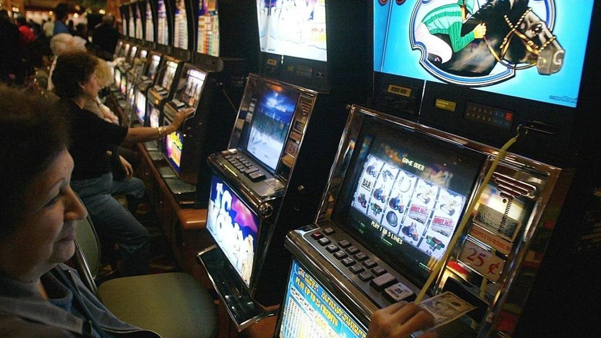 LEDE -- A customer plays a slot machine at the Pechanga Resort & Casino in Temecula, Calif in 2003. The Brown administration and tribe recently negotiated a 5,500-slot machine compact that awaits ratification by the Legislature.